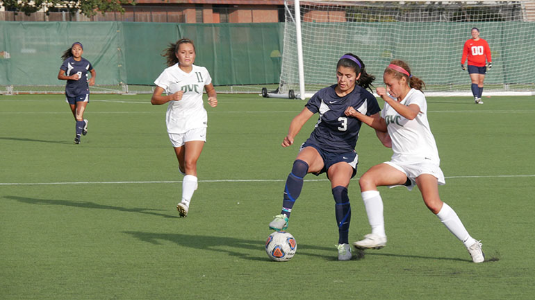 Forward Pricilla Villalobos fends off opponent in the 2-1 win over Diablo Valley College on Oct. 14.