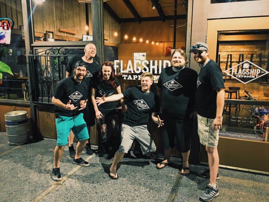 The Flagship staff, ready to set sail, poses for a photo in front of their restaurant.