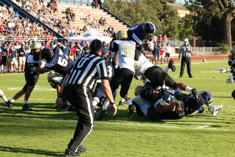 SRJCs Jay Ferguson leaps over the pile at the goal line to score a touchdown on a one yard run at Bailey Field. 