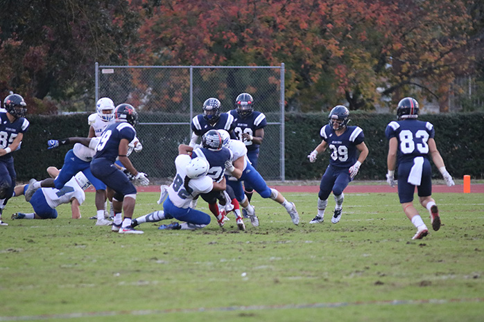 San Mateo players gang tackle Bear Cubs running back JaNarrick James in SRJCs 26-23 loss in the Bay 6 Championship.