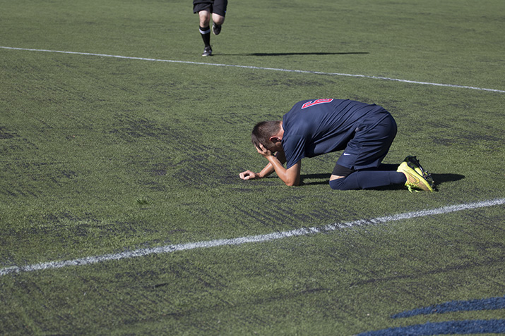 SRJC freshmen midfielder Tony Holleran cradles his head after colliding with an opponent on Aug 30.