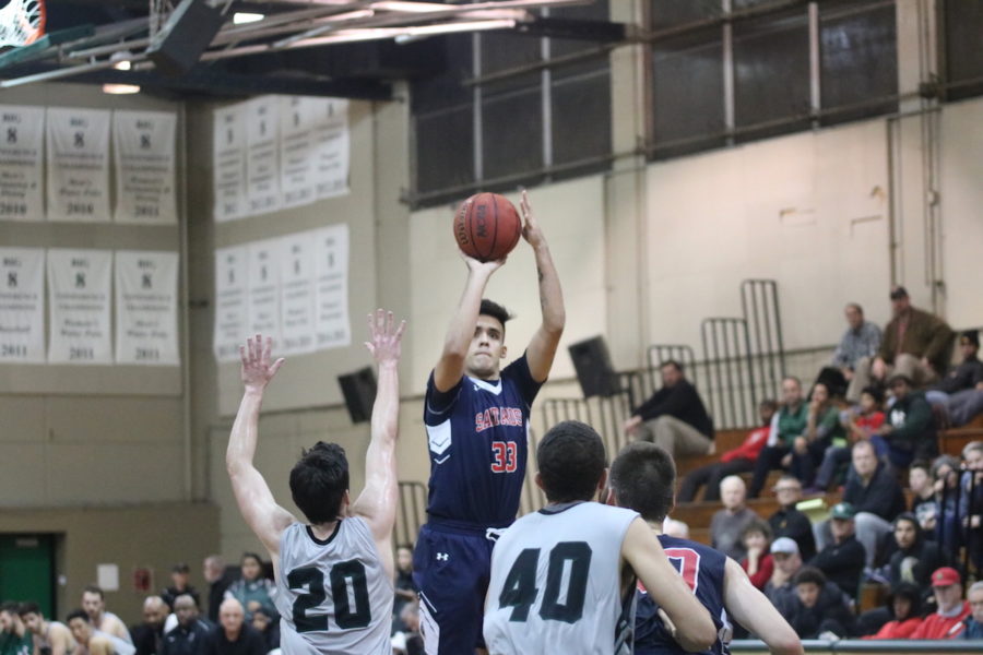 First-year student guard Gabe Knight shooting from behind the arc.