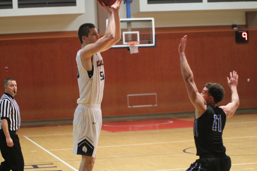 First year Erik Poulsen shooting over his defender for three points