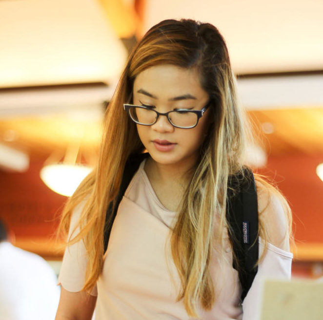 One student looks over brochures from a display of information for college transfer.