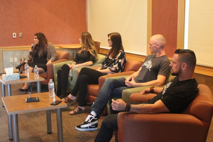 President Evelyn Navarro (far-left) and club founder Ryan Sansome (far-right) share their struggles on a five-student panel.