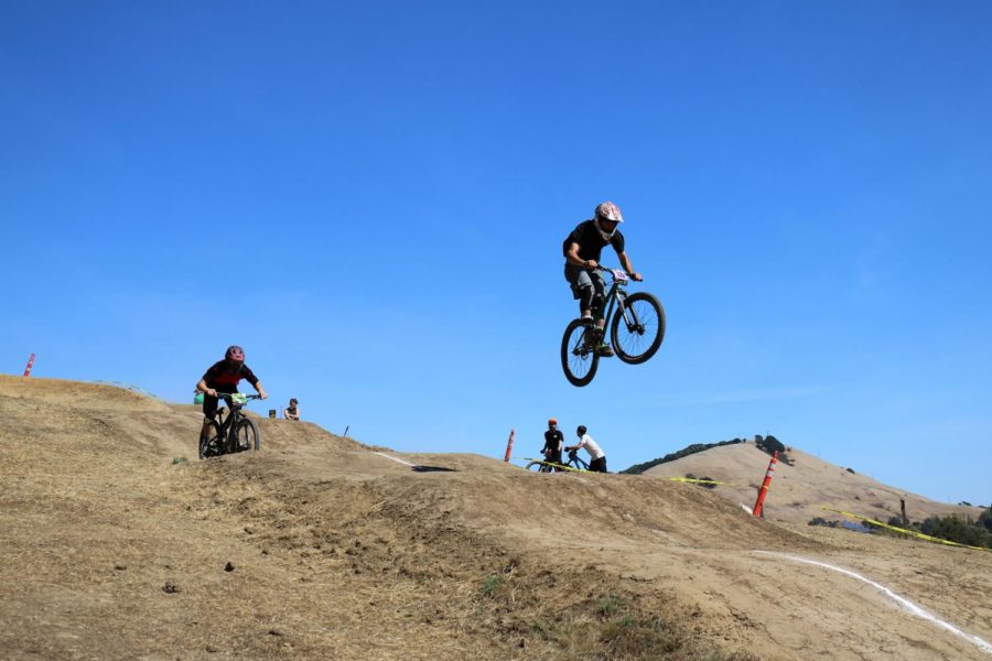 A rider sends the biggest jump on the course.