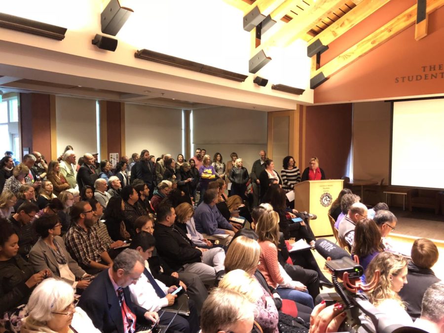 Speakers address a packed room during the public comment period at the Dec. 12 Board of Trustees meeting. Photo by Rachel Edelstein.