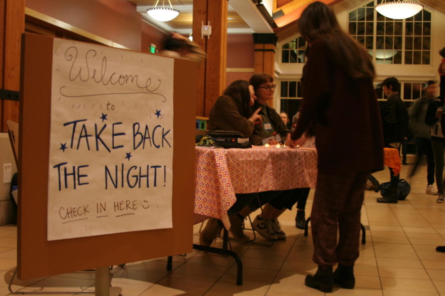 Students+check+in+with+the+Feminists+United+booth+at+the+Take+Back+the+Night+event.