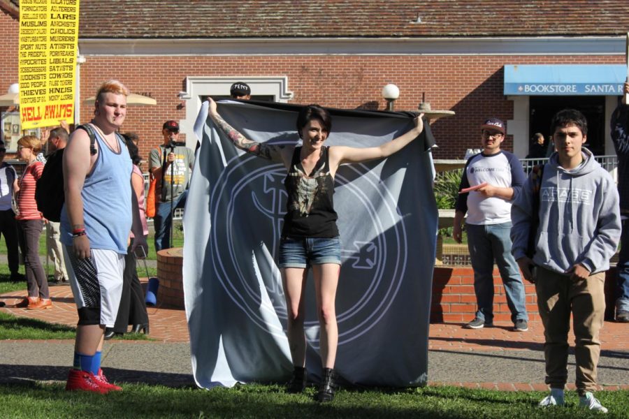 Lauryn Gamble, 26, holds a flag representing Lilith in front of the Cry to God demonstration  Feb. 6 in front of Bertolini.