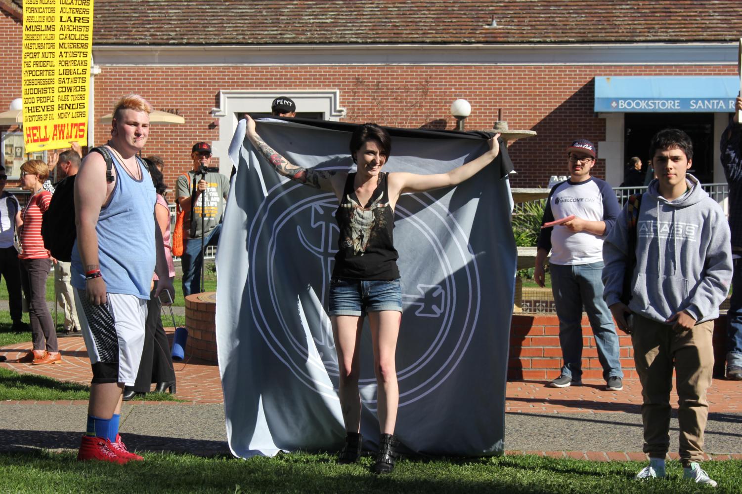 Lauryn Gamble, 26, holds a flag representing Lilith in front of the Cry to God demonstration Feb. 6 in front of Bertolini.
