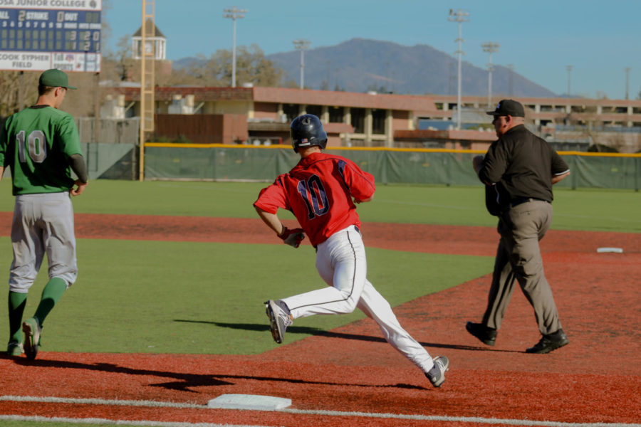 Freshman Hance Smith rounds first base after hitting a base hit in their loss Thursday to Laney College.