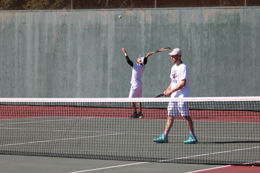 Second-year Andres Jojoa-Ortega serves as first-year Cade Stan readies up during their doubles match Tuesday.