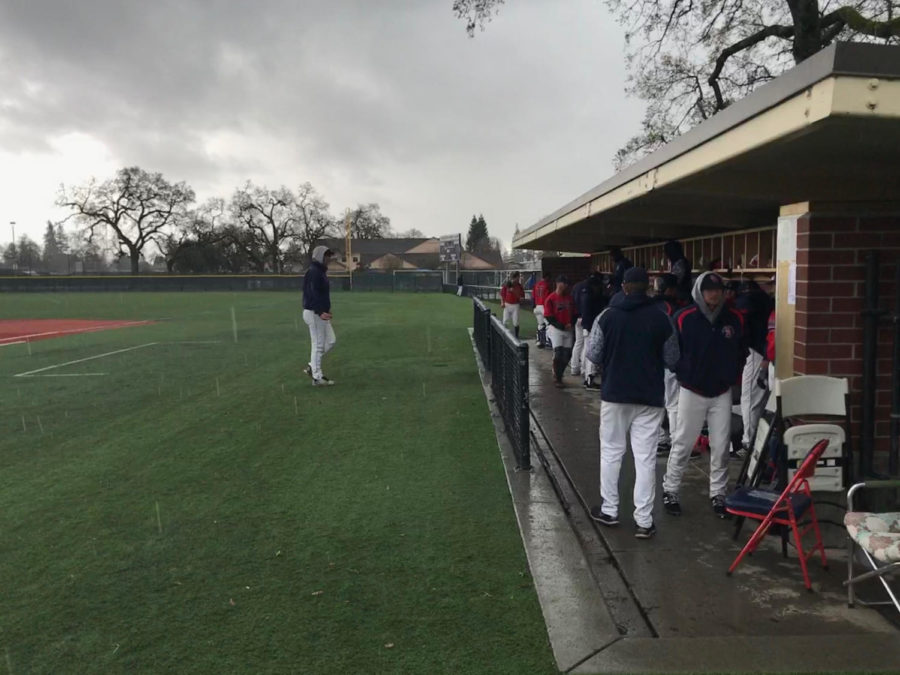 Bear Cubs players wait in their dugout for the rain to cease during the first rain delay of the game.