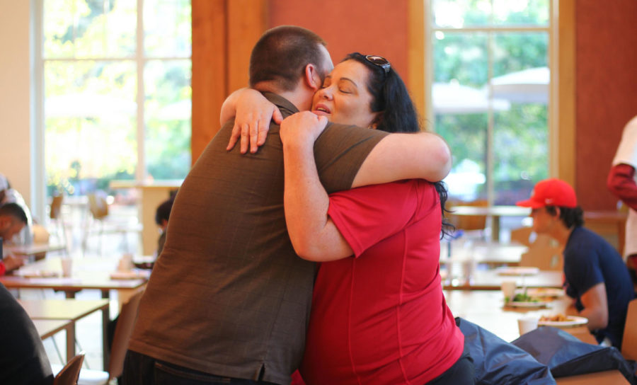 Dori Elder, 35, embraces a former SGA president, Ian Mauer. We did this event for a family type meal, where students can sit down and get together for a meal and meet one another, Elder said.