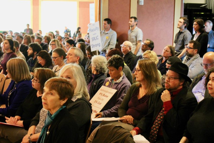 Crowds fill Bertolini Hall leaving standing room only during Tuesdays Board of Trustees meeting.