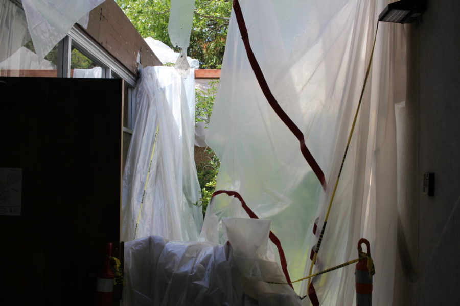 Blown-over tarps hang over Baker Hall.