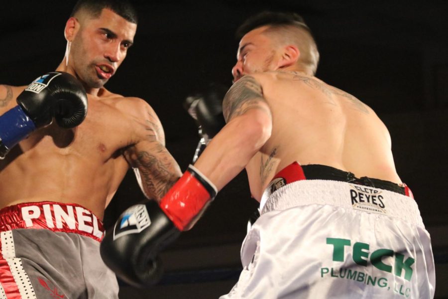 Ricardo Pinell (left) connects with a left hook against Enrique Gallegos (right) in the first round of their bout at the Battle of the Ballroom in San Francisco April 7.