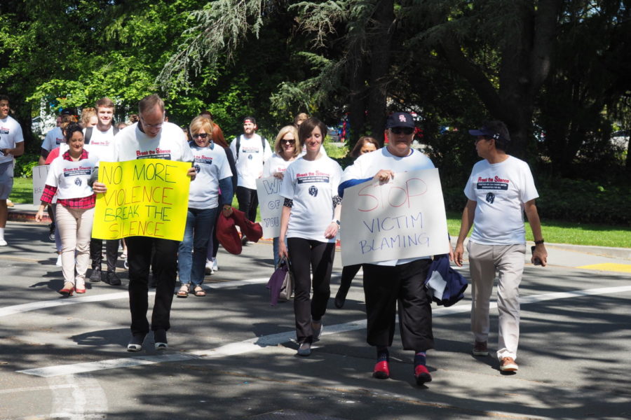 Students and faculty march at the "Walk a mile in her shoes" event. 