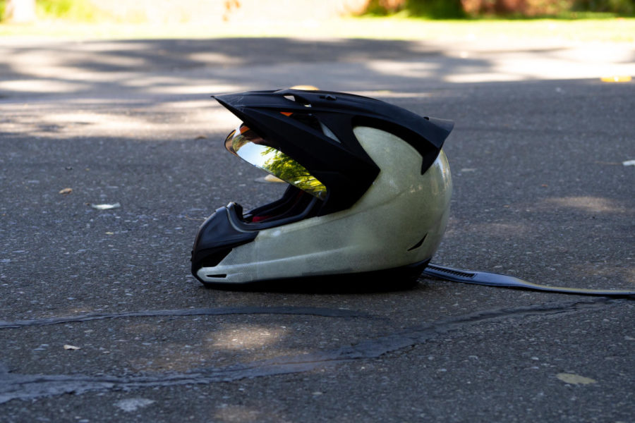 A motorcyclists helmet lays on Elliott Avenue after a collision with a Honda minivan. The motorcyclist was rushed to the hospital with unknown injuries.