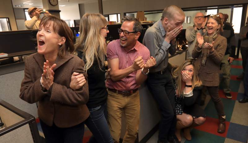 Espinoza (center) and colleagues celebrate the Press Democrat's Pulitzer win. 