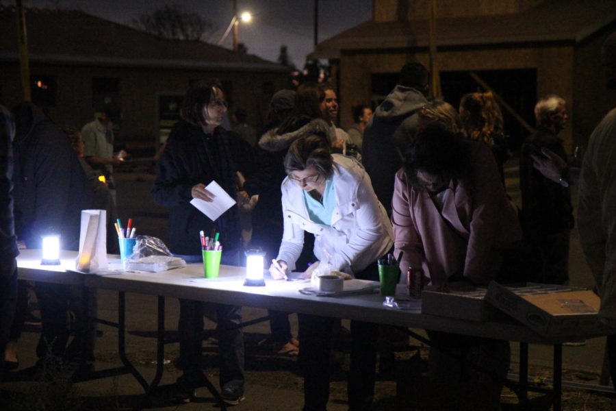 Heavy hearted yet hopeful community members decorate luminaries to light the night of Oct. 9, 2018.