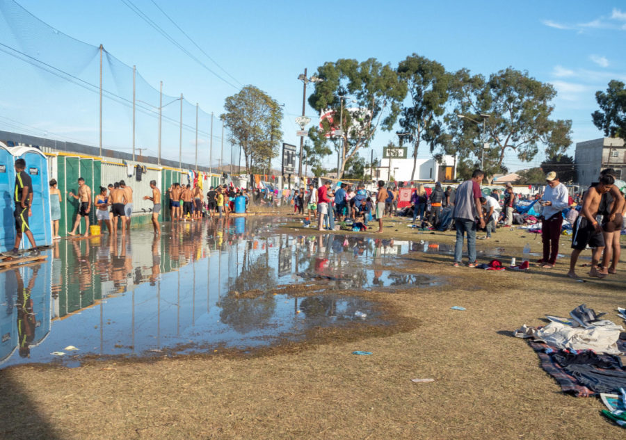 Migrants shower after the 100-mile drive from Mexicali to Tijuana. 