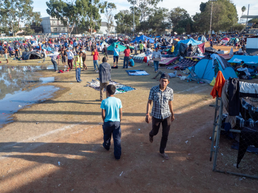 The stadium already exceeding capacity still continues to grow as water from the showers begins to flood an overcrowded tent city. 