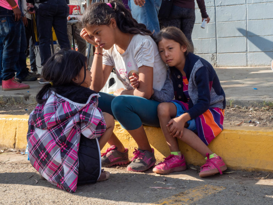 Three sisters sit on the curb in front of Benito Juarez sports center, worried about the disappearance of their mother, who left with a friend to find food the previous night.