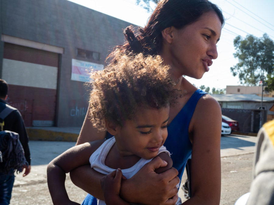 Getting out of a semi-truck, packed with over 50 people, a 16-year-old girl and her nephew take a walk for fresh air. 