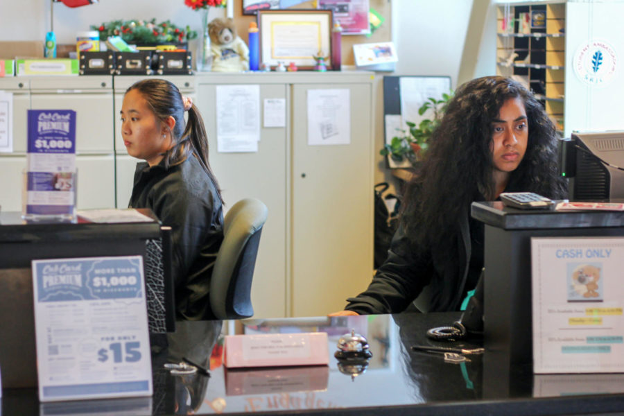 At the Student Services desk, Student Ambassadors Jesse Pagulayan, 19 (left) and Anna Kidd, 21, (right) assist the students slowly filtering in throughout the day in between finishing their final assignments of the semester. “It’s usually very lively in here, but by the end of the semester no one wants to be on campus because of the stress,” Kidd said. “I overhear conversations between students on campus and all they’re talking about are grades, finals and tests, you can see the stress on their faces.”