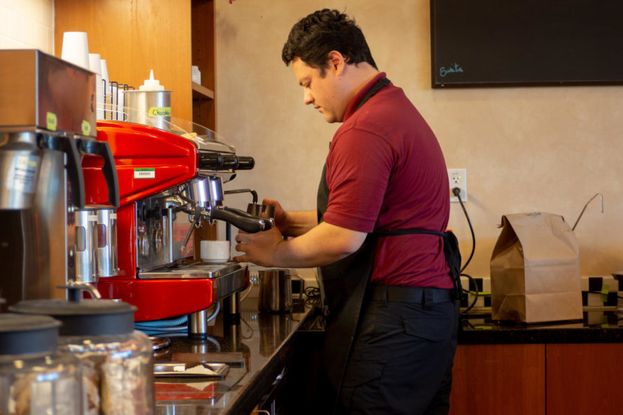 Joshua Pinaula foams milk at the Culinary Café & Bakery where SRJC culinary students bake the cafés offering. 