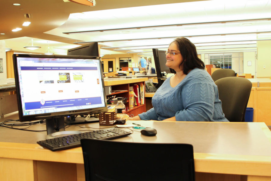 Smita Avasthi, a public services librarian, works at the reserve desk inside Doyle library.