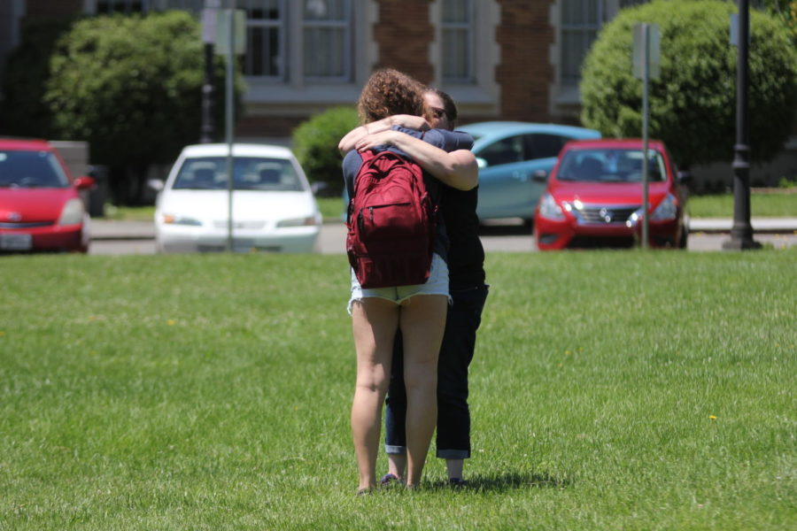 A reunited mother and daughter embrace each other in front of Santa Rosa High School.