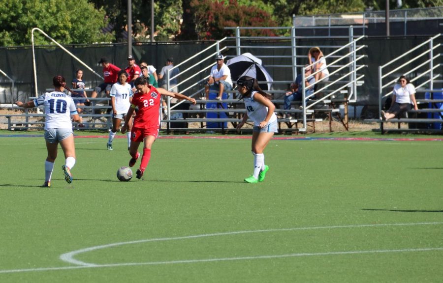 SRJCs captain Gizela Carranza passes through two Clovis defenders on Tuesdays game. 