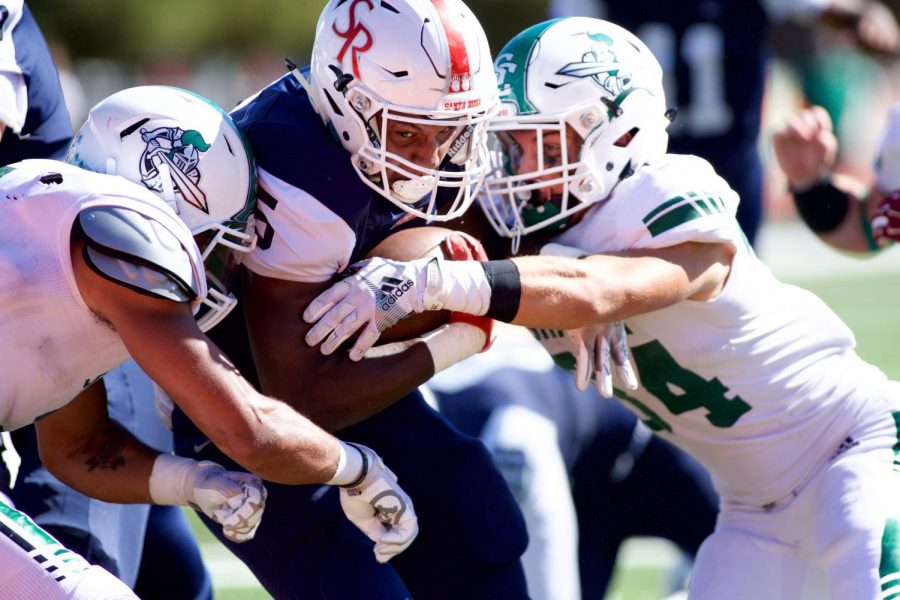 Santa Rosa running back Maceo Barbosa (5) protects the rock from Shasta College's defense at Santa Rosa High School Sept. 21 in Santa Rosa. [Joseph Barkoff]