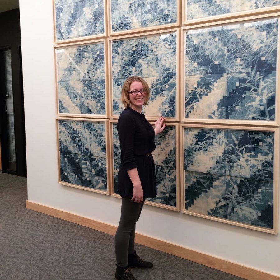 Robert F. Agrella Gallery art director and printmaking professor Hannah Skoonberg, stands with her own art during a printmaking exhibition called The Farthest Shore,” an installation she curated Hannah in February 2018.