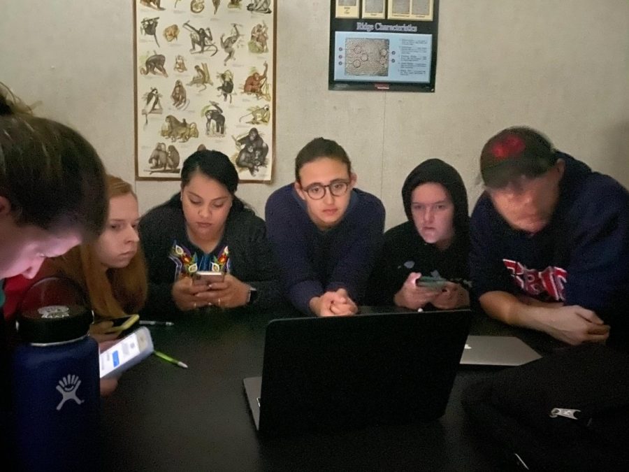 Anthropology Lab students watch ABC7 news live stream in the dark during the Oct. 22 lockdown. 