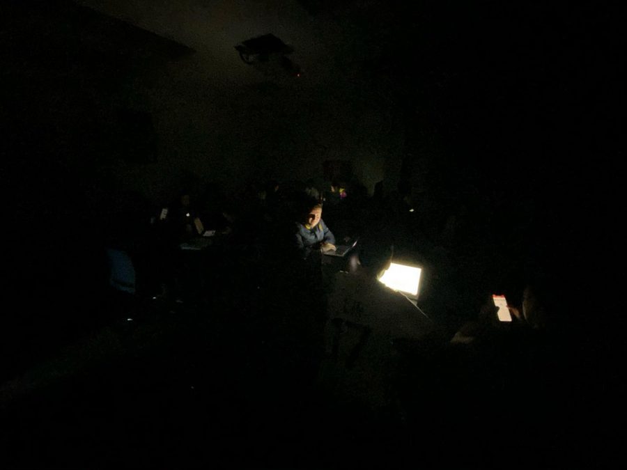 Santa Rosa Junior College Anthropology Lab students reading news in the dark as they wait for the all clear.