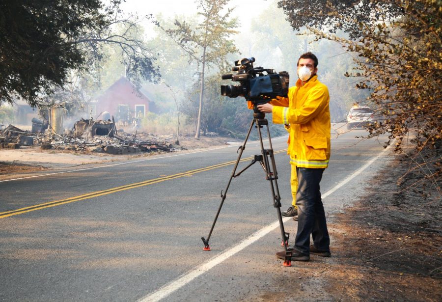 A cameramen records the destruction of several structures on Alexander Valley Road.