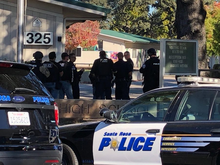 Local law enforcement huddles in front of Ridgway High to plan their entry into classrooms.