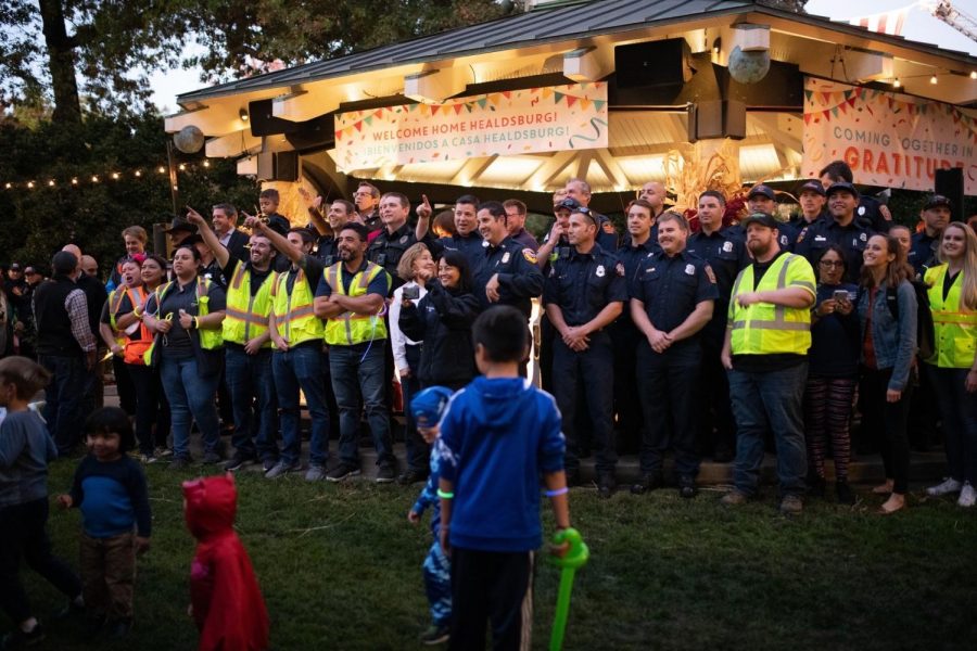 Firefighters, police officers and Healdsburg city staff gather Friday, Nov. 8 at the Healdsburg Plaza on the night of "Coming Together in Gratitude," days after the Kincade Fire.