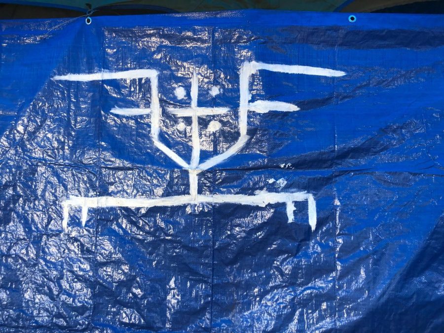 Mouseys personal crest representing friends, family, freedom forever that he painted on the tarp that defines his home on the Joe Rodota Trail.