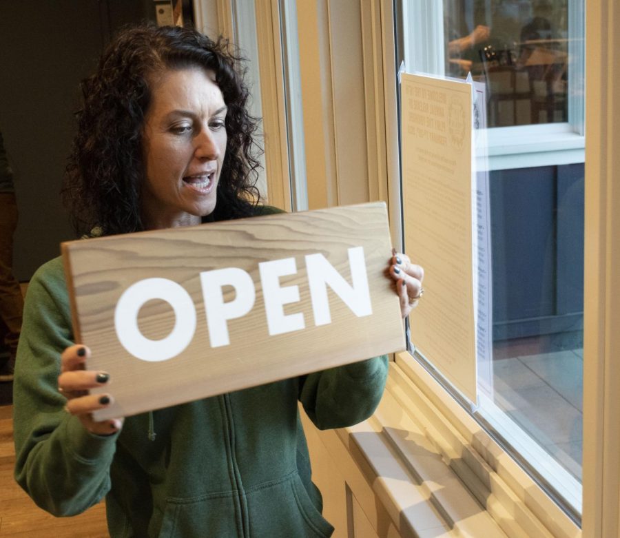 RRBC owner, Natalie Cilurzo, enthusiastically flips the restaurant-bar sign to "OPEN" at their brewery headquarters. According to Cilurzo, this year's turnout for the yearly release of Pliny the Younger at their flagship location is notably larger than in  years past.