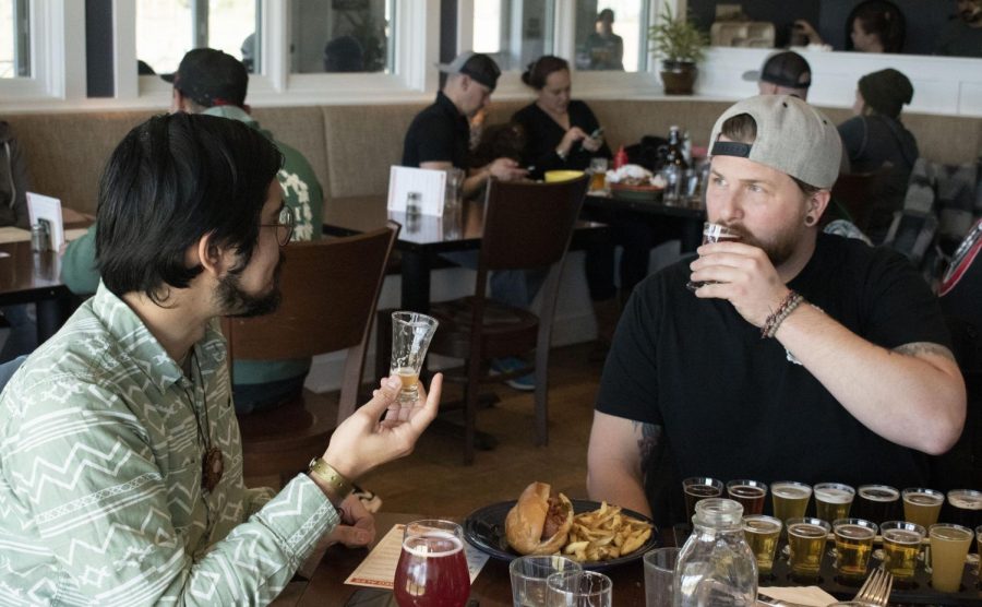 Craft-beer video-podcast producer, Jacob Talamantes, and host, Jeffery Craig, take shots from a flight of beers in between tastes of Pliny the Younger.