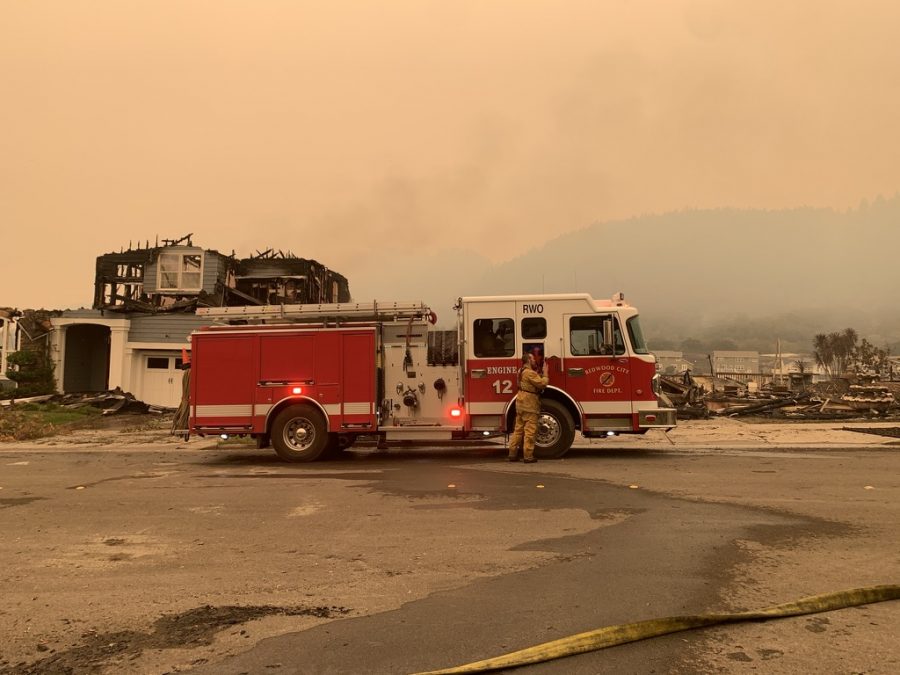 A fire engine from San Mateo County's Redwood City Fire Department sits in front of multiple destroyed homes on Mountain Hawk Drive in Santa Rosa.