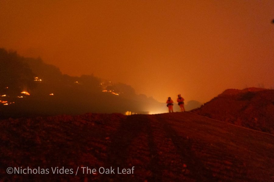 Firefighters observe a dozer cutting a fire break into the mountain overlooking the Skyhawk community at 1 a.m. Monday in Santa Rosa.