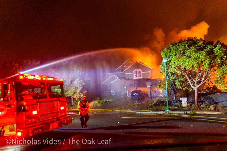 An engine douses a house on Mountain Hawk Road early Monday morning to keep embers from catching other houses on fire in the Mountain Hawk Area of Santa Rosa, CA.