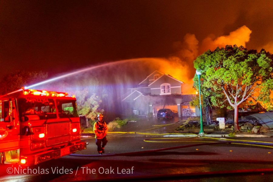 An engine douses a house on Mountain Hawk Road early Monday morning to keep embers from catching other houses on fire in the Mountain Hawk Area of Santa Rosa, CA.