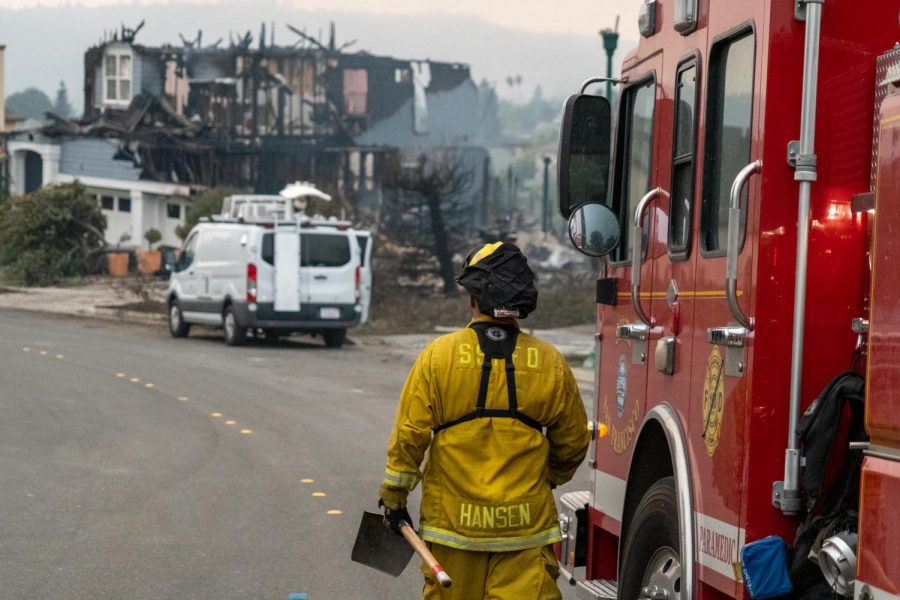 A firefighter returns on Monday to overhaul the smoldering wreckage of a home in the Skyhawk neighborhood that burned the previous night.