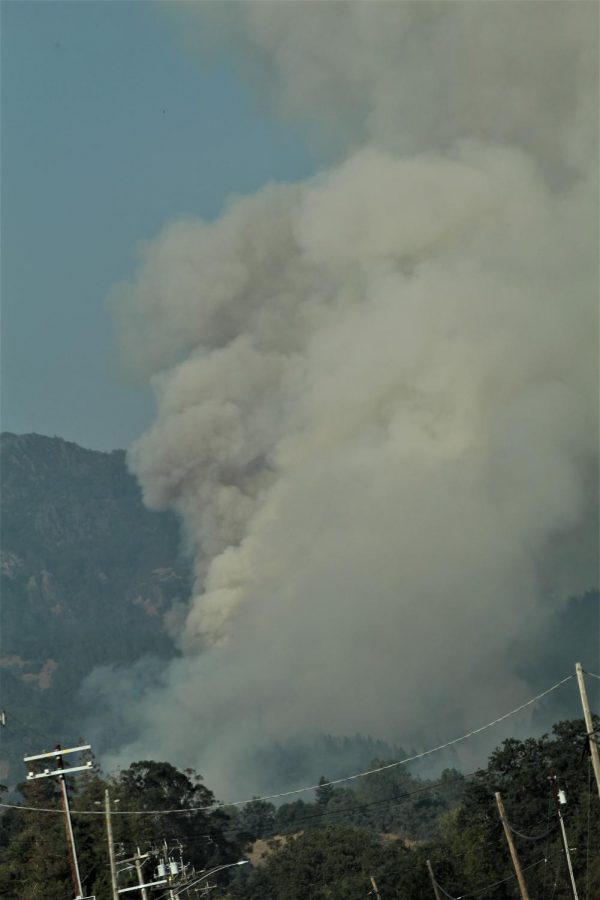 Plumes of smoke billow into the air over Highway 128.